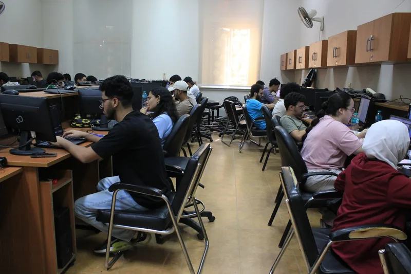 Students working at computers during a Coach Academy university training session